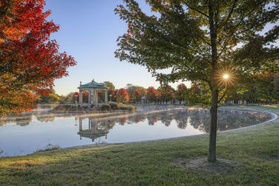 Scenic view of lake by trees against sky during autumn