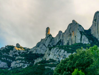 Low angle view of rock formations against sky