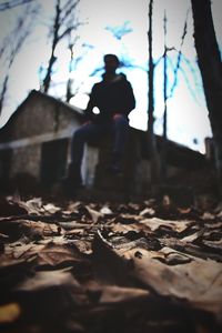 Man standing by leaves during autumn