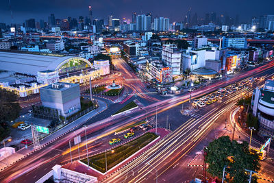 High angle view of illuminated city street and buildings at night