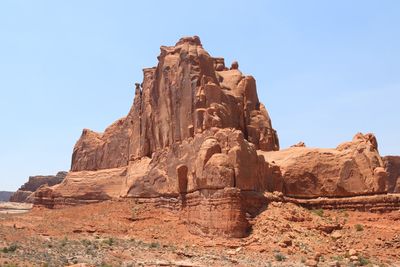 Low angle view of rock formations at arches national park against clear sky