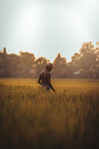 Man on field against sky