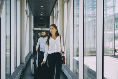 Woman walking in corridor of building