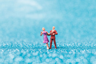 Rear view of a couple on sea shore against sky