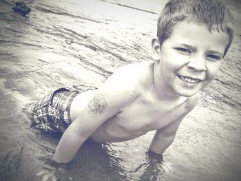 Close-up portrait of smiling mid adult man at beach