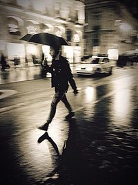 Blurred motion of man walking on road