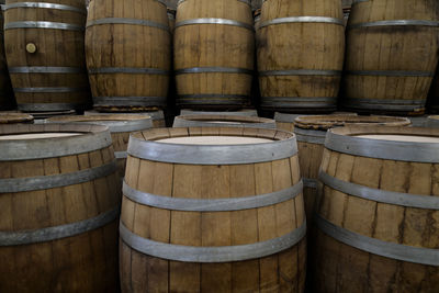 Full frame shot of wine bottles. barrels 