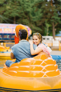 Happy couple in love riding a water ride in an amusement park