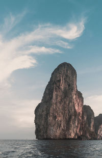 Rock formation in sea against sky