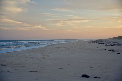 Scenic view of beach against sky during sunset