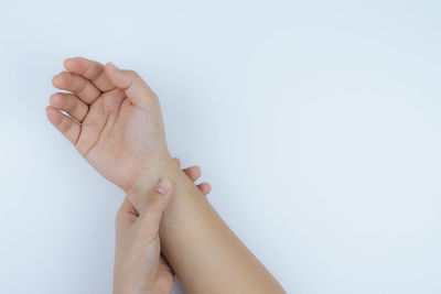 Low section of woman against white background