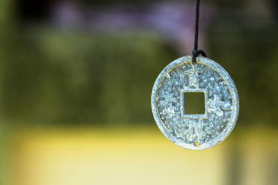 Close-up of electric lamp hanging on metal