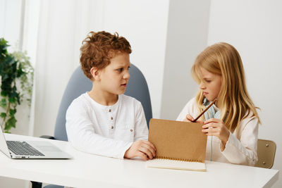 Young woman using laptop at home