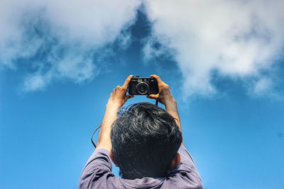 Photographer photographing through camera