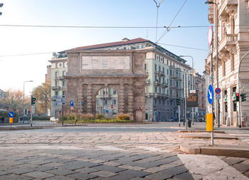 Buildings in city against clear sky