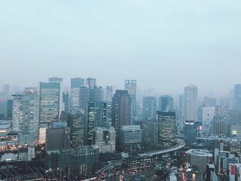 High angle view of modern buildings in city against sky