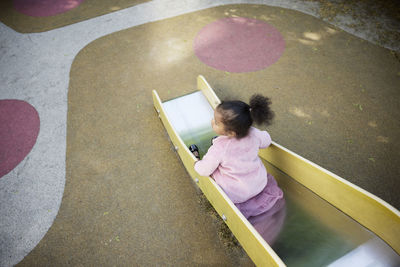 Girl having fun on slide in playground