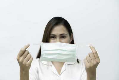 Portrait of a woman wearing hat against white background