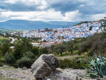 View of cityscape against cloudy sky