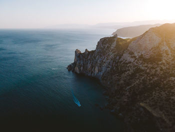 Rock formations in sea against sky