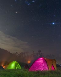 Scenic view of tent against sky at night