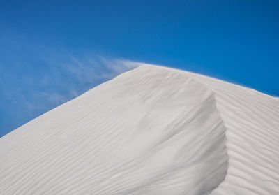 Scenic view of desert against clear blue sky