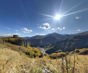 Scenic view of mountains against sky on sunny day