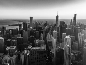 Aerial view of modern buildings in city against sky