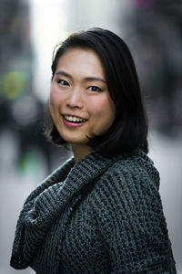 Close-up portrait of happy young woman outdoors