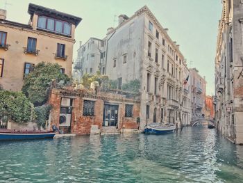 Canal amidst buildings in city