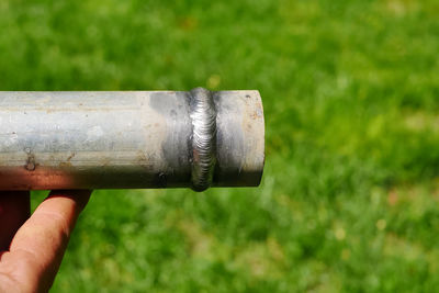 Close-up of human hand holding metal