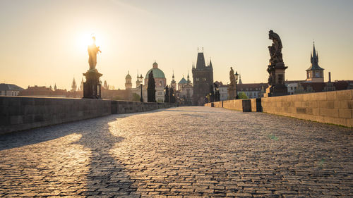 Charles bridge in prague, czech republic. scenic view of baroque statues and the old town in morning