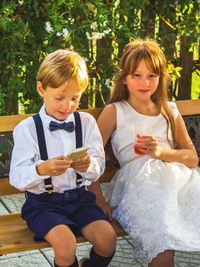 Portrait of girl siting by brother