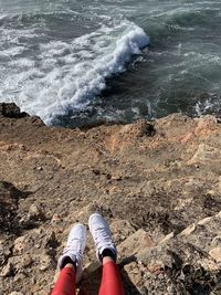 Low section of people on rock in sea