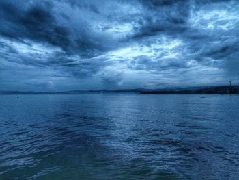 Scenic view of sea against cloudy sky