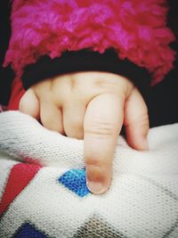 Low section of baby feet on bed
