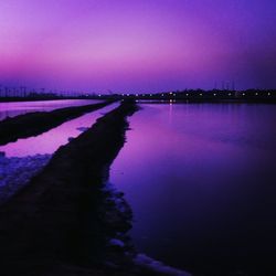 Scenic view of lake against sky at sunset