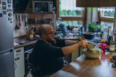 Rear view of woman sitting on table