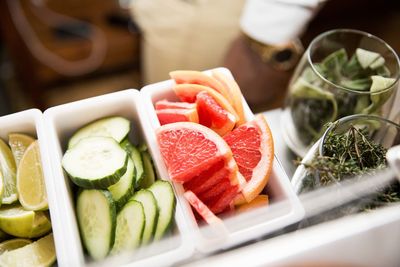 Slice of cucumber and citrus fruit with glass of leaf