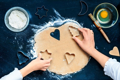 High angle view of woman and child making cookies