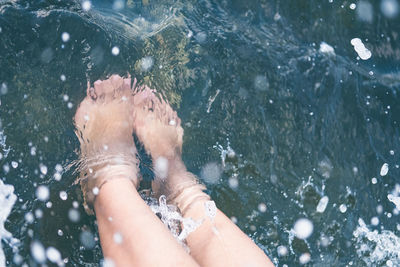 Low section of woman in water