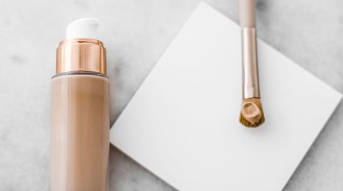 High angle view of beauty products over white background