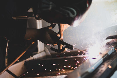 Cropped image of man welding metal