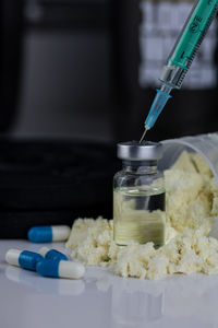 Close-up of dentures with pills on table