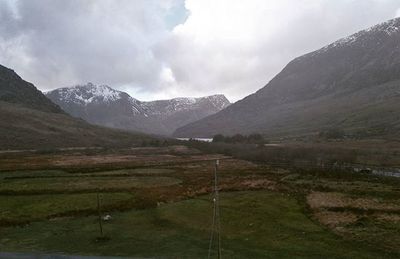 Scenic view of mountains against cloudy sky