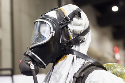 Person wearing gas mask standing outdoors