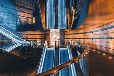 Light trails on bridge seen through glass of building