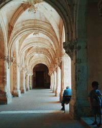 Man walking in corridor of building