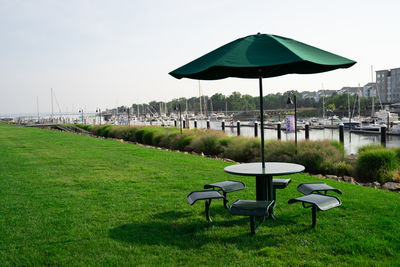 Chairs and tables in row against sky