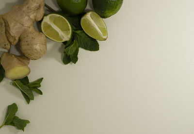 Close-up of fruits and leaves against white background